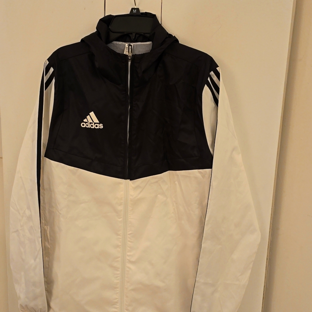 Adidas wind jacket big boys size large is new but I took of tags